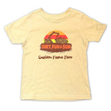 Beige t-shirt with a graphic design of a sun, truck, and excavator on a white background.